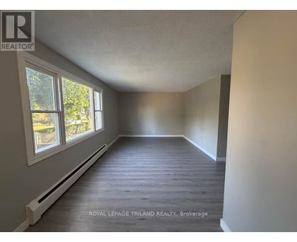 A room with a window and a white radiator on the wall.