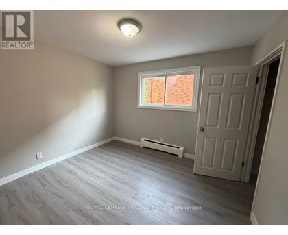 A room with a door, window, and a wall-mounted air conditioner.