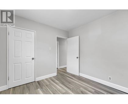 A white door is on the left and an open white door is on the right.