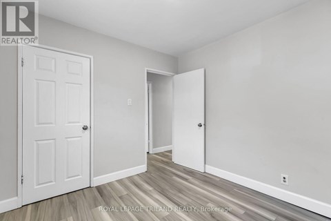 A white door is on the left and an open white door is on the right.