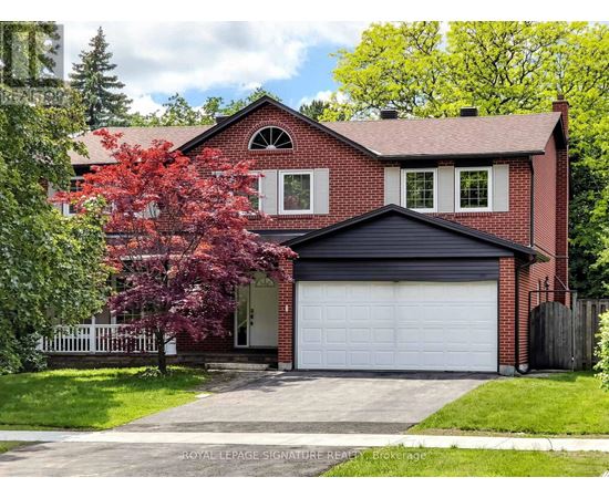 A red brick house with a white garage door.