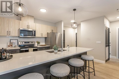 A modern kitchen with a large island and bar stools.