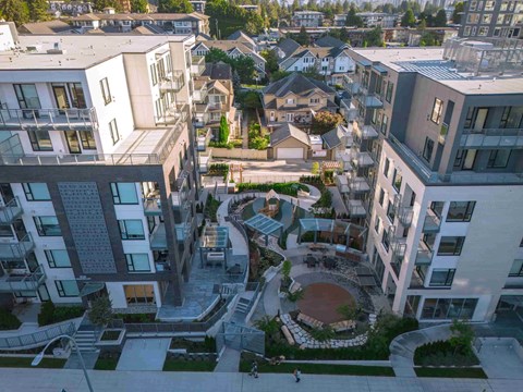 A modern residential area with apartment buildings and a central courtyard.