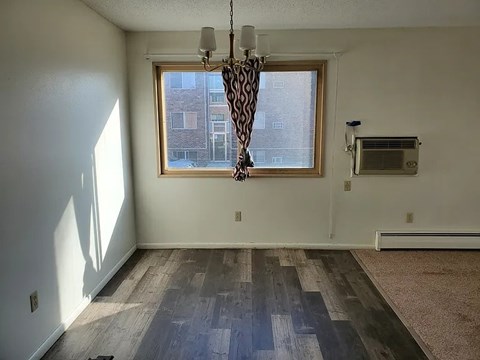 A room with a window and a fan.