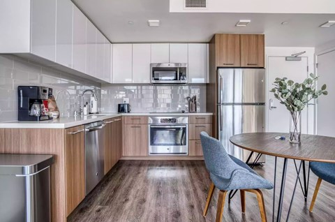A modern kitchen with wooden cabinets and stainless steel appliances.