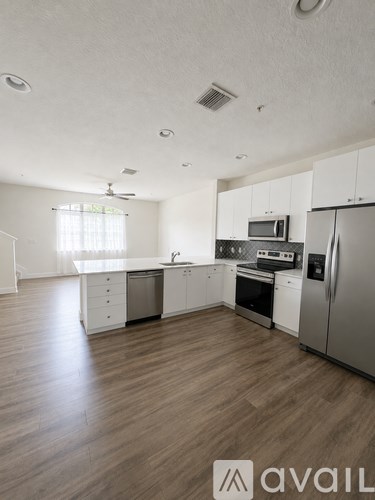 A kitchen with white cabinets and stainless steel appliances.
