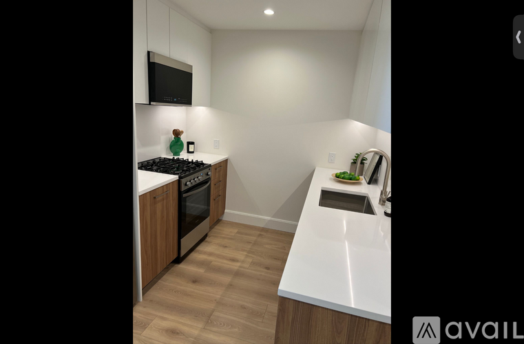 A kitchen with a stove and a microwave on the counter.