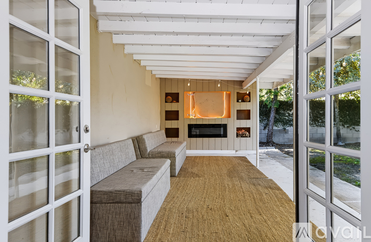 A living room with a grey couch and a wooden floor.