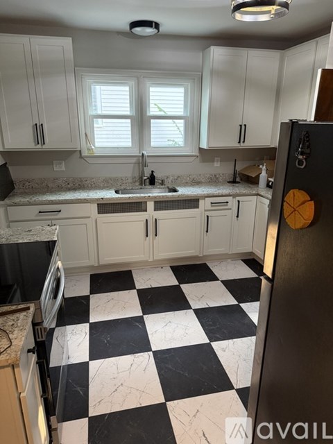 A kitchen with black and white checkered floor.