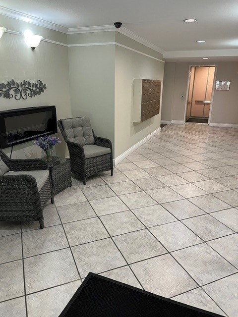A living room with a black couch, a chair, and a television.