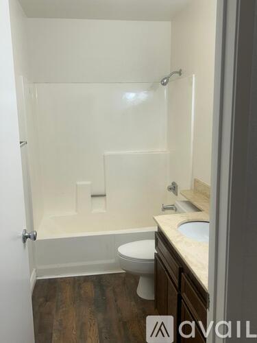 A bathroom with a toilet, sink, and shower.