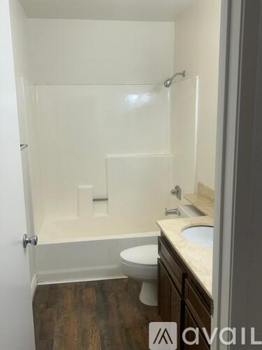 A bathroom with a toilet, sink, and shower.