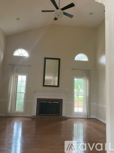 A living room with a fireplace and a mirror on the wall.