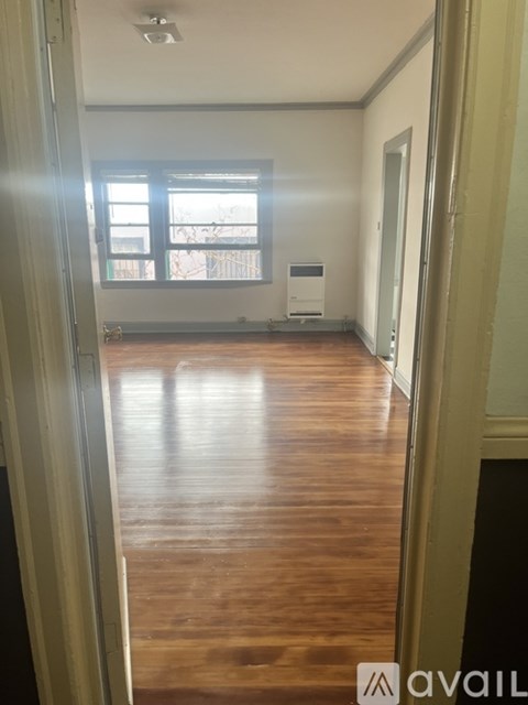 A room with wooden floors and a window.