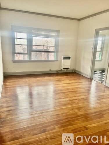 A room with wooden floors and a window.