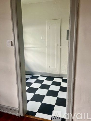 A hallway with a black and white checkered floor.