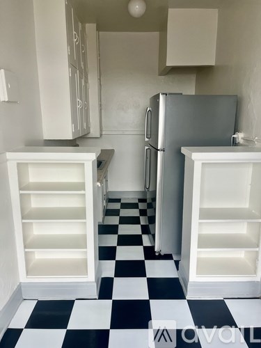 A black and white checkered floor in a kitchen.