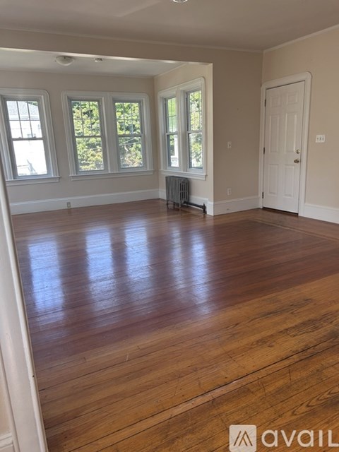 A room with wooden floors and a white door.