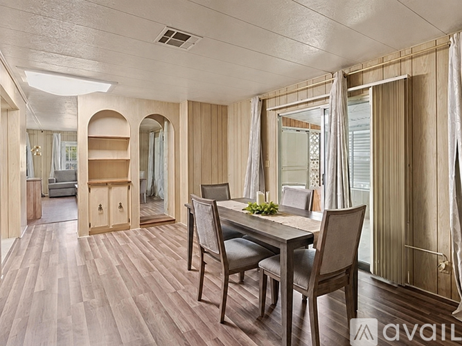A dining room with a table and chairs.