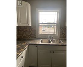 A kitchen with a sink and a window.