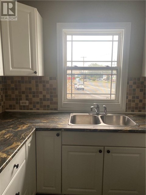 A kitchen with a sink and a window.