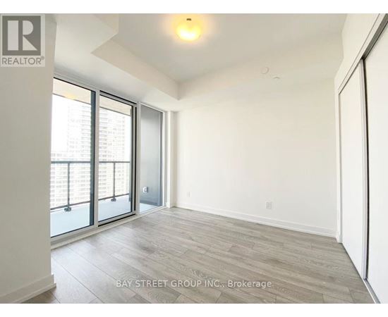 A spacious room with a view of the city through the windows.