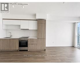 A modern kitchen with a stove top oven and a sink.