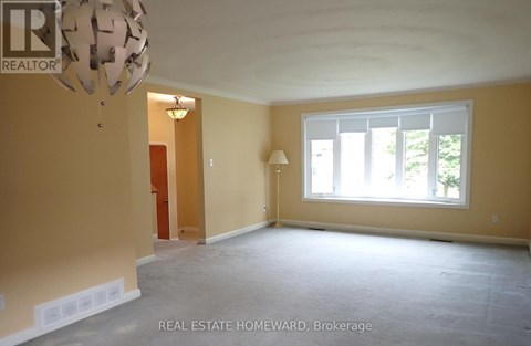 Empty room with a window and a lamp.