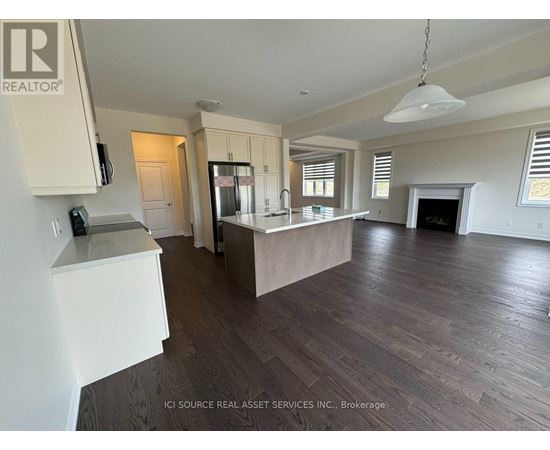 A spacious kitchen with white cabinets and a large island.