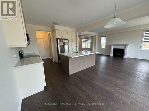 A spacious kitchen with white cabinets and a large island.