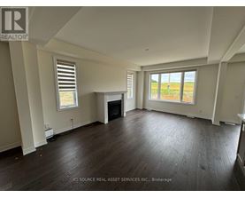 A spacious living room with hardwood floors and a fireplace.