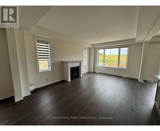 A spacious living room with hardwood floors and a fireplace.