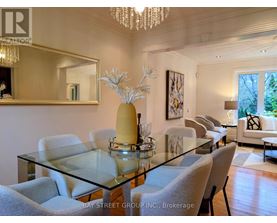 A dining room with a glass table and chairs.