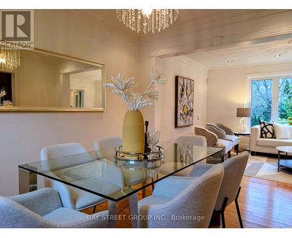A dining room with a glass table and chairs.