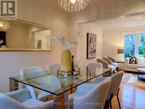 A dining room with a glass table and chairs.