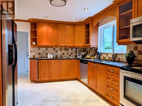 A kitchen with wooden cabinets and a black countertop.