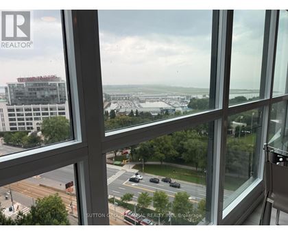 A view from a window looking out at a cityscape.