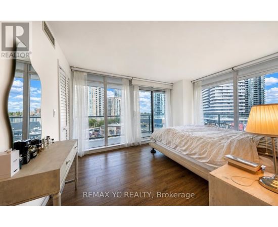 A bedroom with a large bed and a view of the city.