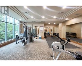 A gym with a variety of equipment including a rowing machine.