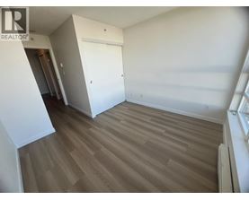 A room with wooden flooring and a white door.