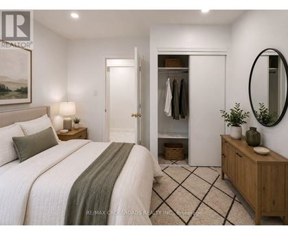 A bedroom with a large bed and a wardrobe.