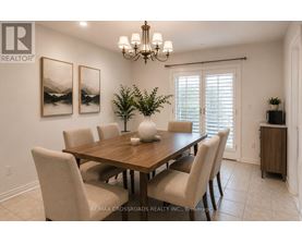 A dining room with a wooden table and chairs.