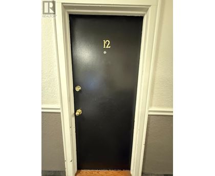 A black door with the number 12 on it.