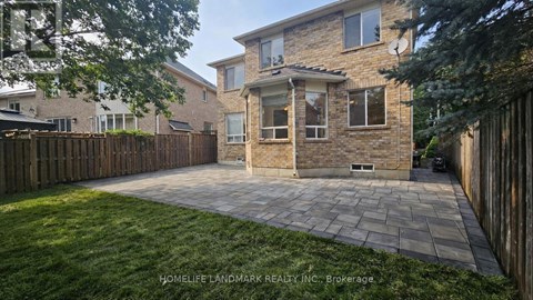 A house with a stone facade and a wooden fence.