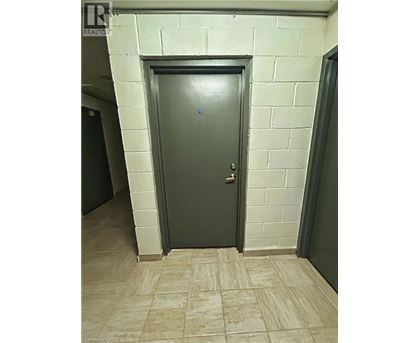 A grey door in a room with a tiled floor.