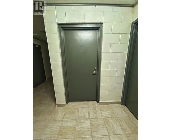 A grey door in a room with a tiled floor.