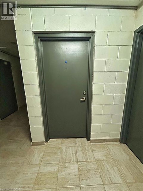 A grey door in a room with a tiled floor.