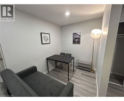 A living room with a grey couch and a black table.