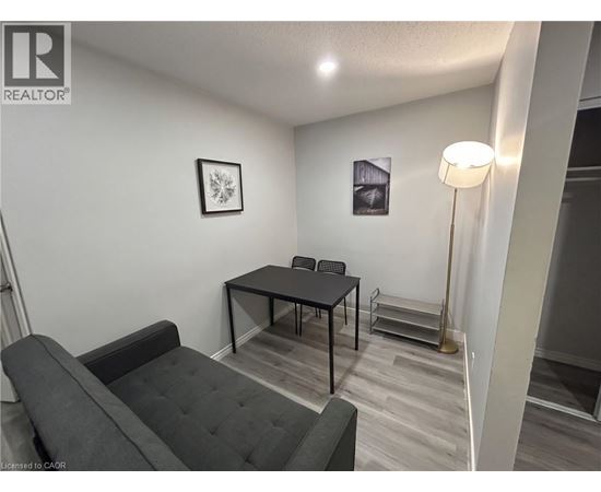 A living room with a grey couch and a black table.