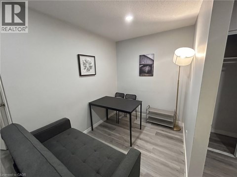 A living room with a grey couch and a black table.